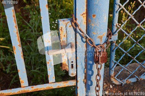 Image of Old gate with padlock and chain