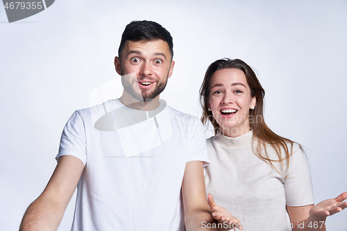 Image of Happy surprised young couple in amazement