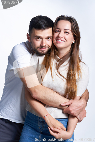 Image of Smiling young couple hugging