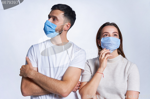 Image of Young couple wearing medicine masks