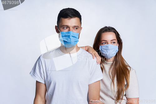 Image of Young couple wearing medicine masks