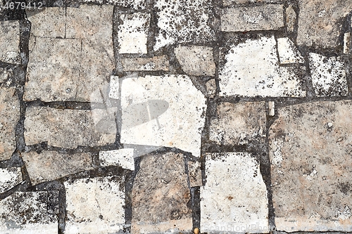 Image of Stone pavement broken near construction