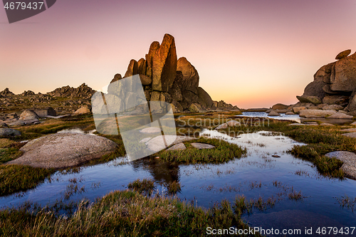 Image of Rocky Tor in Snowy Mountains surrounded by blue pools