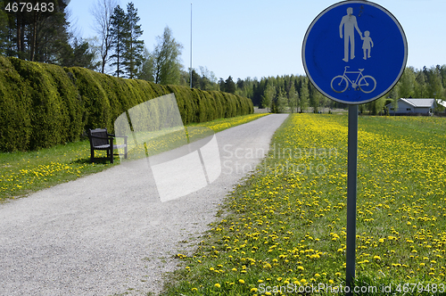 Image of bicycle and footpath along the hedge in Finland