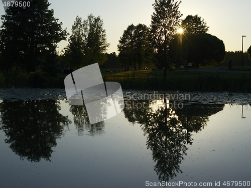 Image of warm evening in the park by the lake