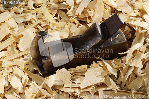 Image of a lot of fresh wood shavings and vintage planer