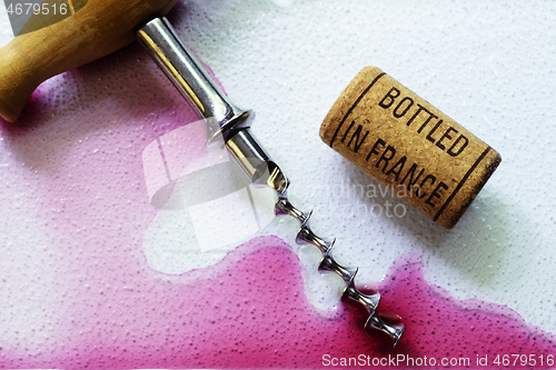 Image of vintage old corkscrew and wine cork 