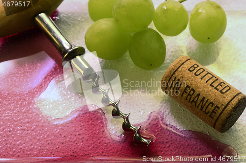 Image of vintage old corkscrew, wine and wine cork 