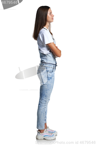 Image of Full length profile portrait of a teen girl standing looking in front