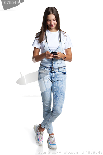Image of Smiling teen girl with smart phone in hands,
