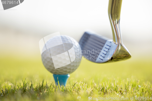 Image of Golf ball on tee in front of driver