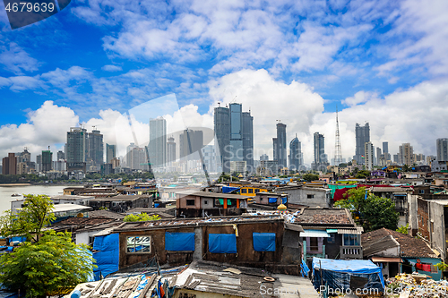 Image of Views of slums on the shores of mumbai, India against the backdr