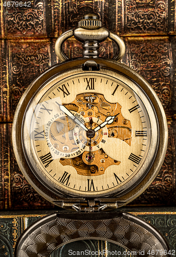 Image of Antique clock dial close-up. Vintage pocket watch.