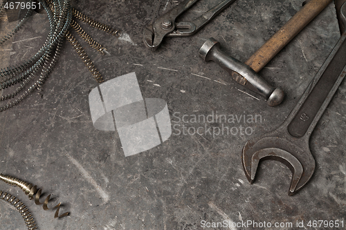 Image of Old tools set on a vintage metallic background with space for text