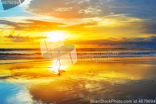Image of Surfer in sunbeams. Bali island