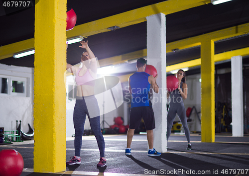 Image of young athletes working out with medical ball