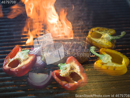 Image of steak with vegetables on a barbecue