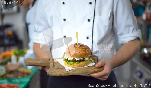 Image of chef finishing burger