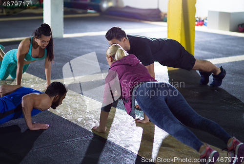 Image of young healthy people doing pushups