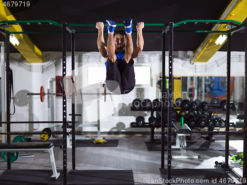 Image of man doing pull ups on the horizontal bar