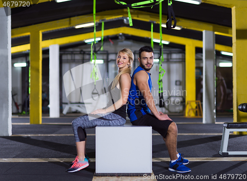 Image of portrait of athletes working out  jumping on fit box