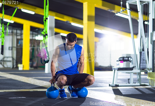 Image of Young strong man doing pushups