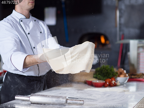 Image of chef throwing up pizza dough
