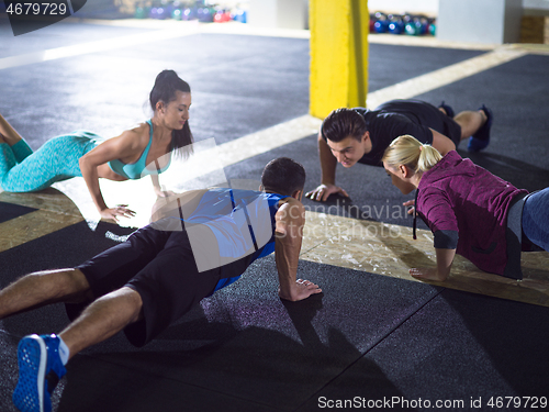 Image of young healthy people doing pushups