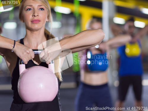 Image of athletes doing exercises with kettlebells