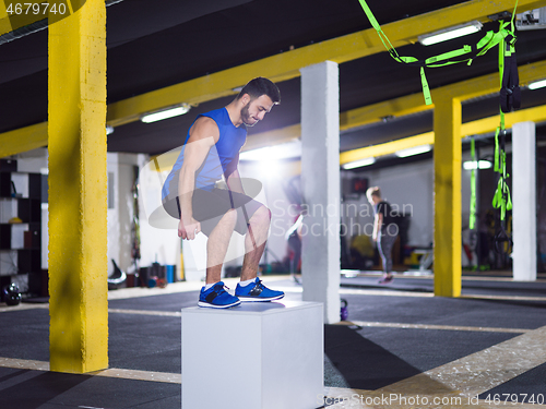 Image of man working out jumping on fit box