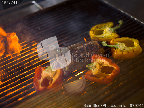 Image of steak with vegetables on a barbecue