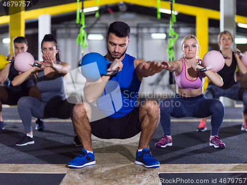 Image of athletes doing exercises with kettlebells