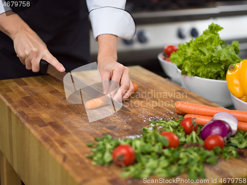 Image of chef hands cutting carrots