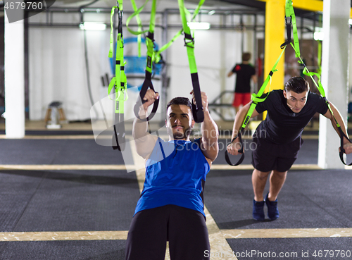 Image of men working out pull ups with gymnastic rings