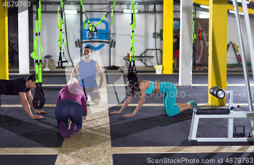 Image of young healthy people doing pushups