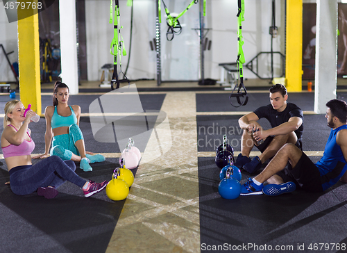 Image of young athletes sitting on the floor and relaxing