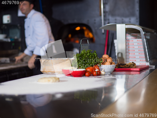 Image of chef preparing dough for pizza