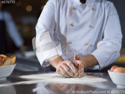 Image of chef hands preparing dough for pizza