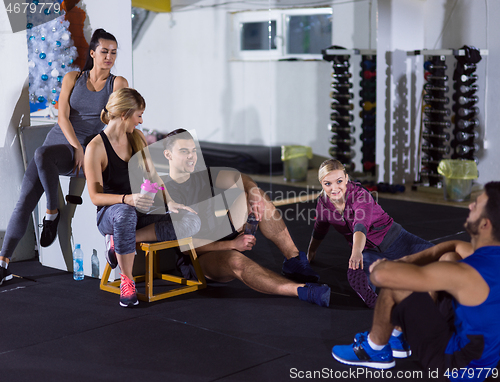 Image of young athletes sitting on the floor and relaxing