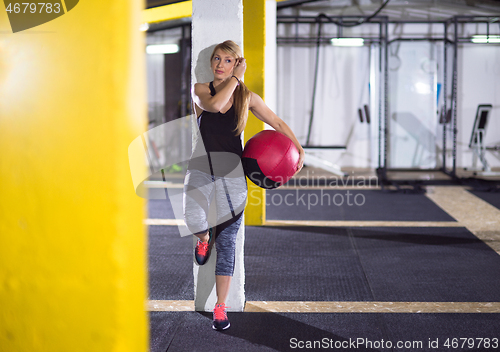 Image of portrait of woman with red crossfitness ball