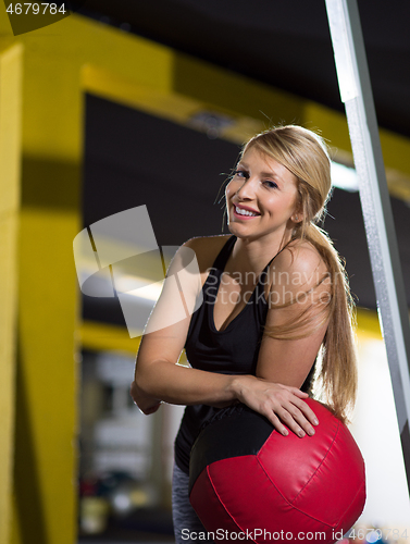 Image of portrait of woman with red crossfitness ball