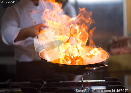 Image of Chef doing flambe on food