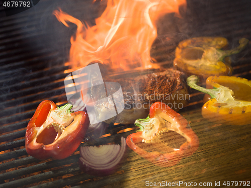 Image of steak with vegetables on a barbecue