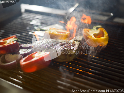 Image of steak with vegetables on a barbecue