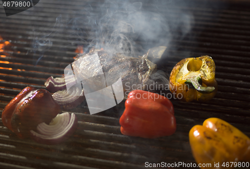 Image of steak with vegetables on a barbecue