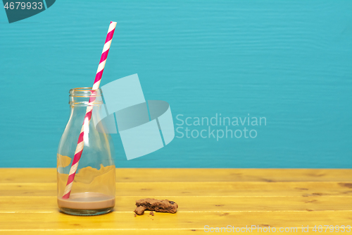 Image of Straw and bottle with dregs of milkshake, and cookie crumbs