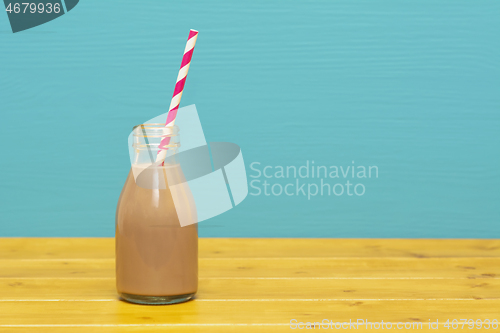 Image of Chocolate milkshake with a retro straw in a glass bottle