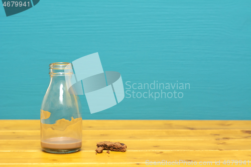 Image of Milk bottle with dregs of chocolate milkshake and cookie crumbs