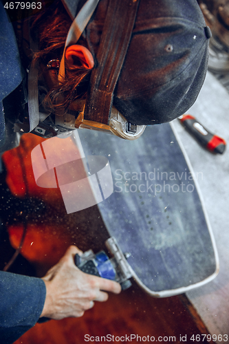 Image of Carpenter using circular saw for cutting wooden boards.