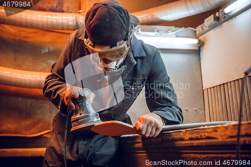 Image of Carpenter using circular saw for cutting wooden boards.